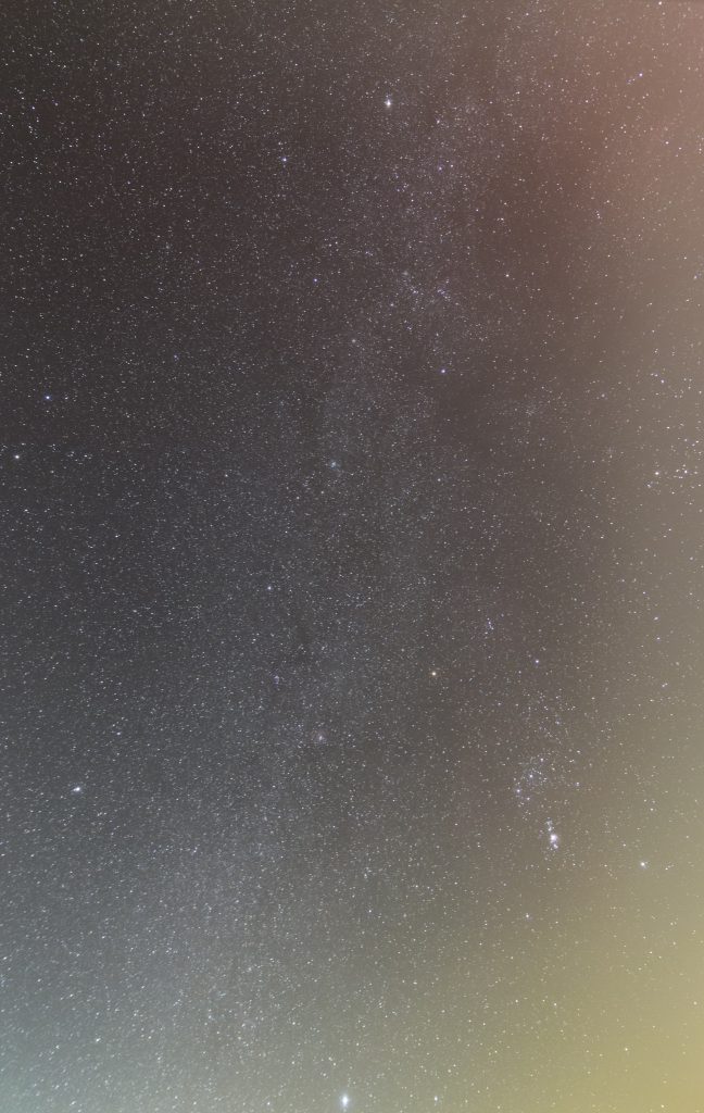 Die Wintermilchstraße von den Sternbildern Großer Hund bis Fuhrmann. Gestackte Aufnahme aus 30x15 Sekunden bei f/2,8 und 24 mm Brennweite und ISO 6400. Streulicht in drei verschiedenen Farben ist links unten, rechts unten und rechts oben zu erkennen. (Bild: B. Knispel)